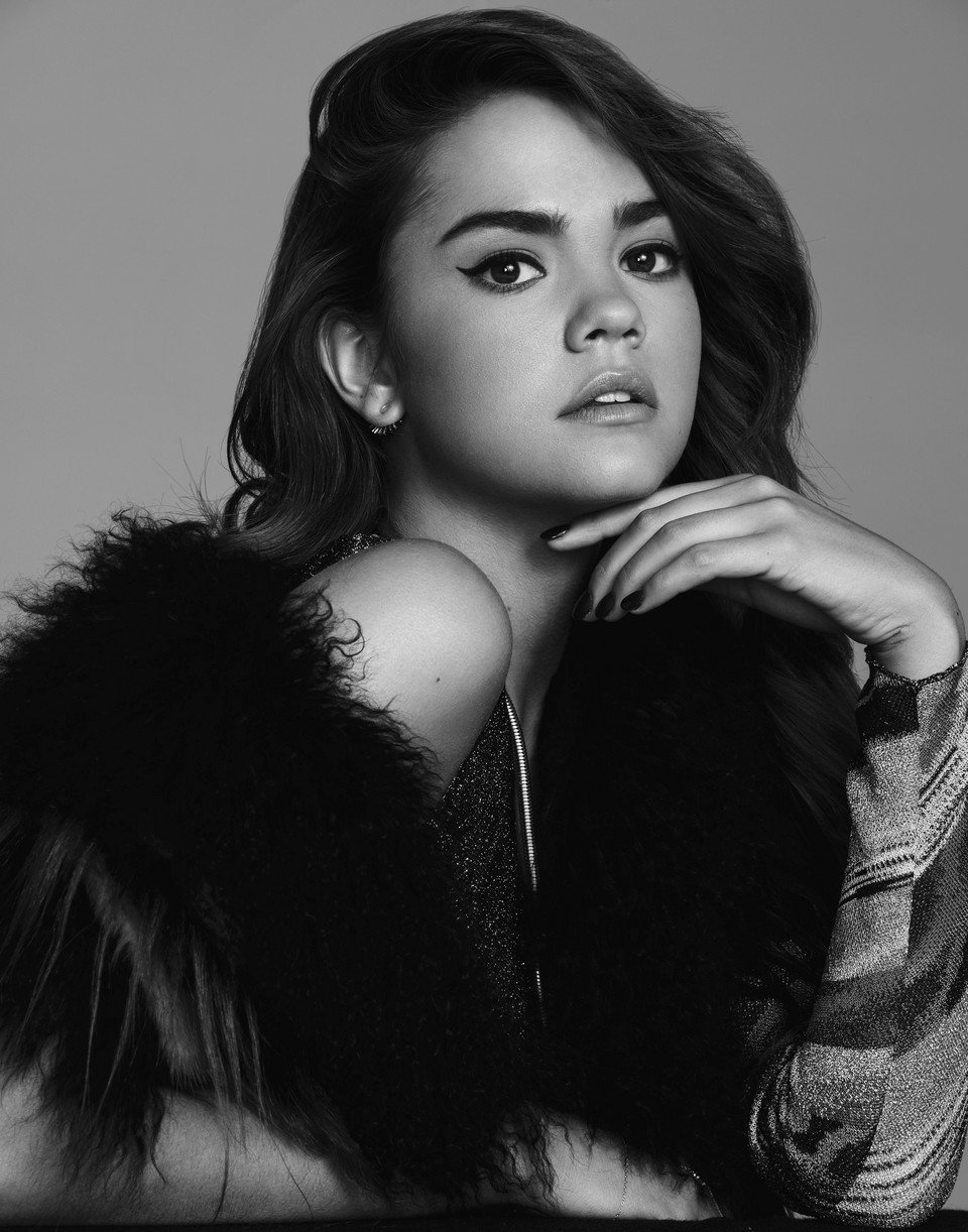 Portrait of Maia Mitchell wearing a feathered look